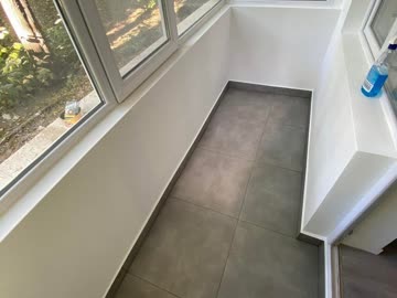 After - Glazed balcony with grey floor tiles