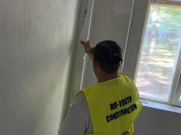 RO Youth operative skimming a wall in an apartment