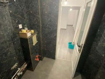After - Bathroom with black marble-effect wall tiles
