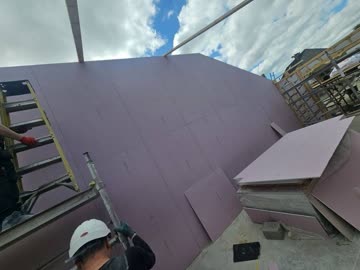 External pink moisture-resistant boarding to timber frame