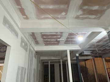 Beam boxing taped out across a retail ceiling