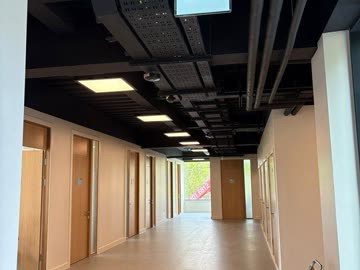Corridor with exposed black ceiling - industrial finish