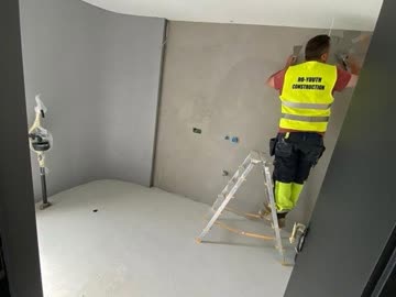 RO Youth team member applying skim coat finish to walls