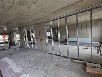 Metal stud partitions set out on a bare concrete floor