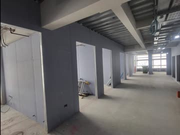 Boarded corridor walls running to a lift core