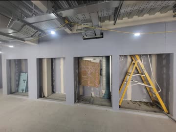 Boarded wall with door openings left out for second fix